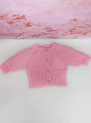 roosa käsitööna kootud kampsun